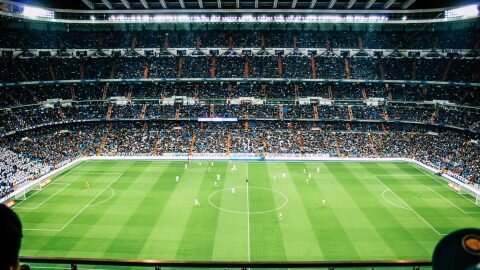 soccer stadium at night with a bright green field