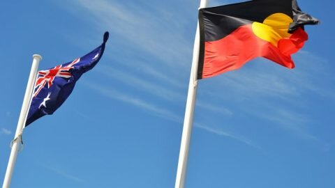 An Australian flag and Aboriginal flag flying side by side