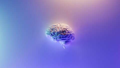Artwork of a glowing brain on a purple gradient background